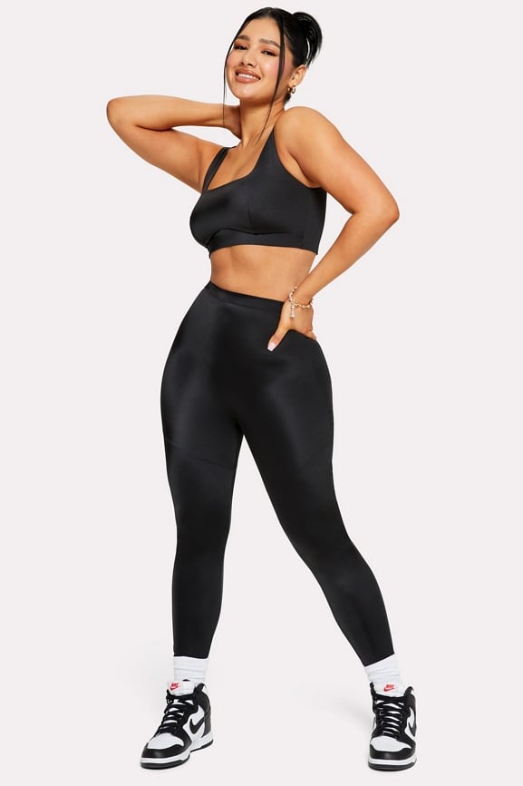 Lizzo sports a black-and-red athletic top and matching leggings